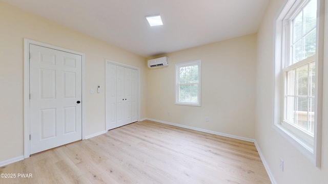136 Heaters Hill Rd, Matamoras, PA 18336 - unfurnished bedroom with a wall mounted air conditioner, light wood-style floors, and a closet