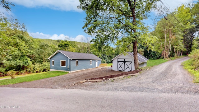 136 Heaters Hill Rd, Matamoras, PA 18336 - view of front of home featuring a garage and a storage unit