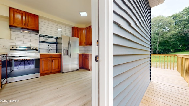 136 Heaters Hill Rd, Matamoras, PA 18336 - kitchen with appliances with stainless steel finishes, tasteful backsplash, light wood finished floors, and plenty of natural light
