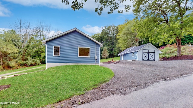 136 Heaters Hill Rd, Matamoras, PA 18336 - view of property exterior featuring a yard, an outdoor structure, and a garage