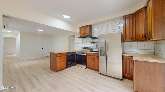 136 Heaters Hill Rd, Matamoras, PA 18336 - kitchen featuring appliances with stainless steel finishes, under cabinet range hood, brown cabinets, a peninsula, and recessed lighting