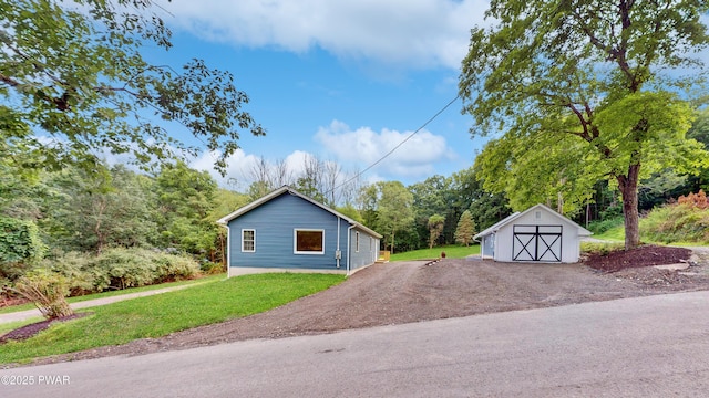 136 Heaters Hill Rd, Matamoras, PA 18336 - view of home's exterior with a garage, a lawn, and a storage shed