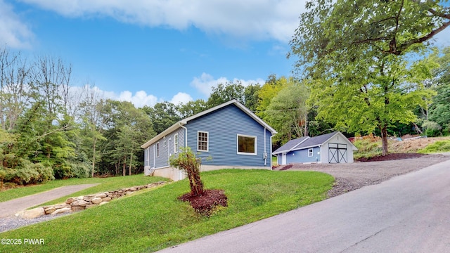 136 Heaters Hill Rd, Matamoras, PA 18336 - view of front of house featuring a front lawn, a detached garage, and a storage shed