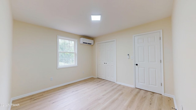 136 Heaters Hill Rd, Matamoras, PA 18336 - unfurnished bedroom with an AC wall unit, wood finished floors, and a closet