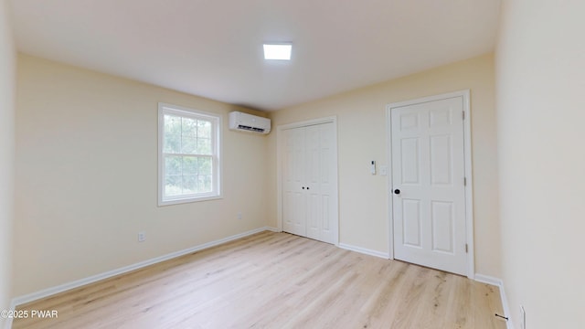 136 Heaters Hill Rd, Matamoras, PA 18336 - unfurnished bedroom with a wall unit AC, wood finished floors, and a closet