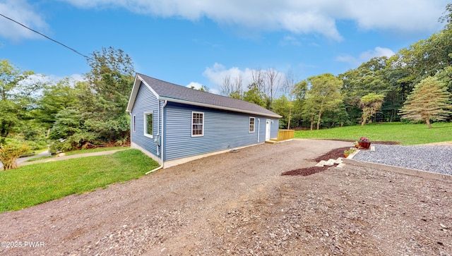 136 Heaters Hill Rd, Matamoras, PA 18336 - view of side of property with a lawn and roof with shingles
