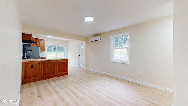 136 Heaters Hill Rd, Matamoras, PA 18336 - kitchen featuring light wood-style flooring, brown cabinets, light countertops, and an AC wall unit