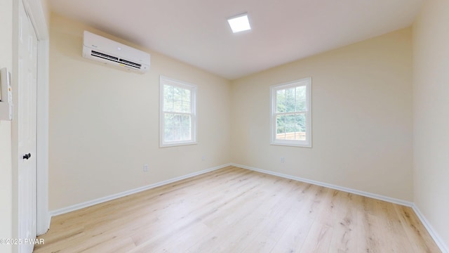 136 Heaters Hill Rd, Matamoras, PA 18336 - empty room with an AC wall unit, light wood-style flooring, and healthy amount of natural light