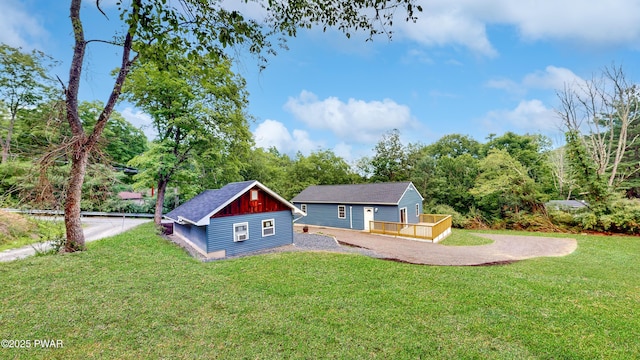 136 Heaters Hill Rd, Matamoras, PA 18336 - rear view of property featuring board and batten siding, a deck, a yard, and an outbuilding