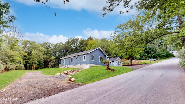 136 Heaters Hill Rd, Matamoras, PA 18336 - view of front of house featuring driveway, a shed, and a front lawn