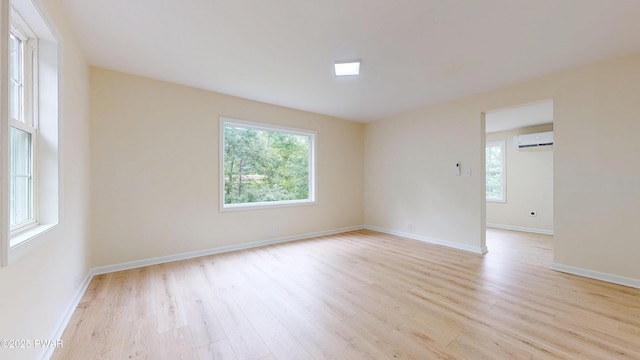 136 Heaters Hill Rd, Matamoras, PA 18336 - unfurnished room featuring a wall unit AC, healthy amount of natural light, and light wood-type flooring