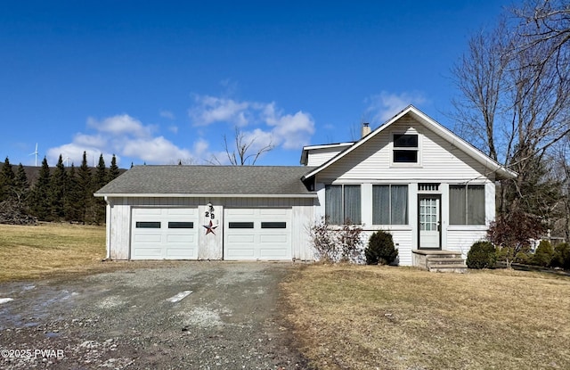 view of front of property with a front yard, an attached garage, driveway, and a shingled roof