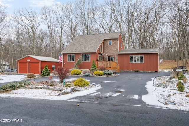 view of front of property with an outbuilding, a garage, and a deck