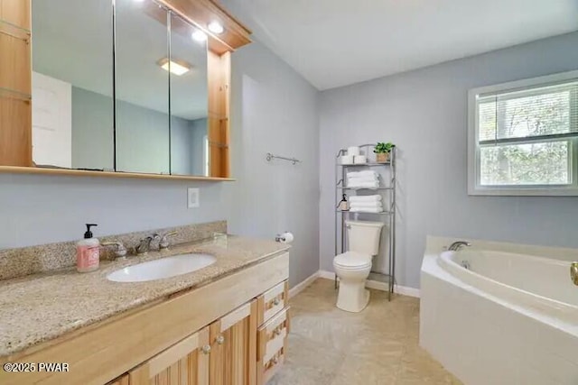 full bath featuring vanity, a garden tub, toilet, and baseboards