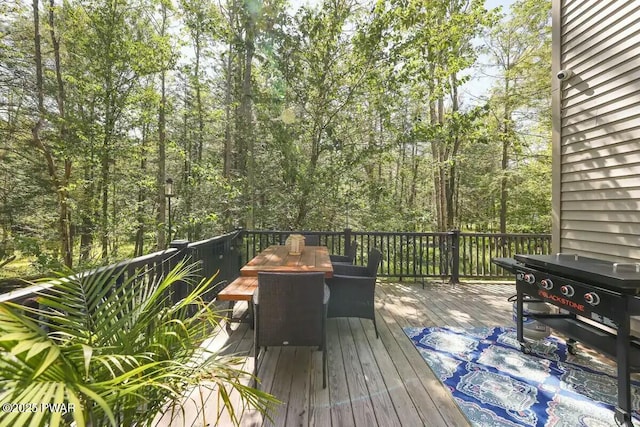 wooden terrace with outdoor dining space