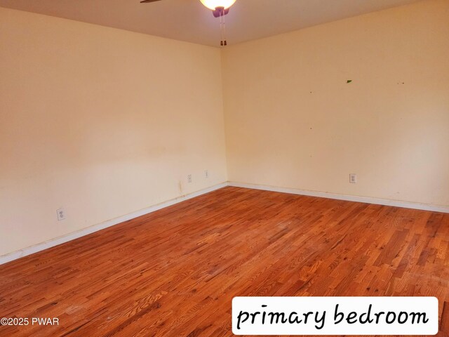 spare room featuring hardwood / wood-style floors and ceiling fan