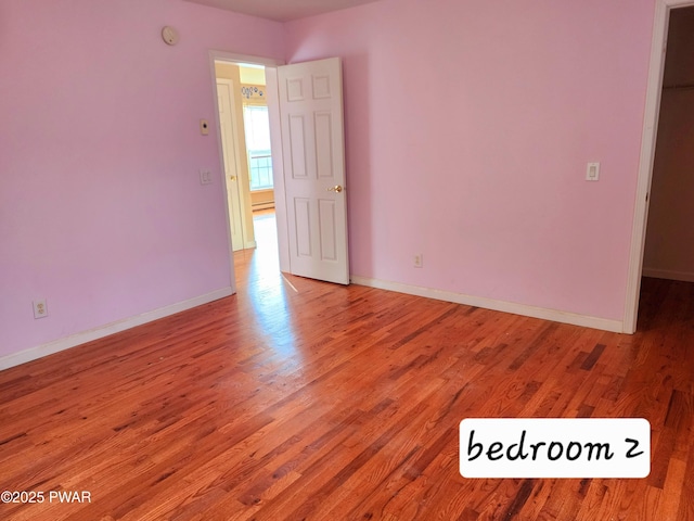 unfurnished room featuring wood-type flooring