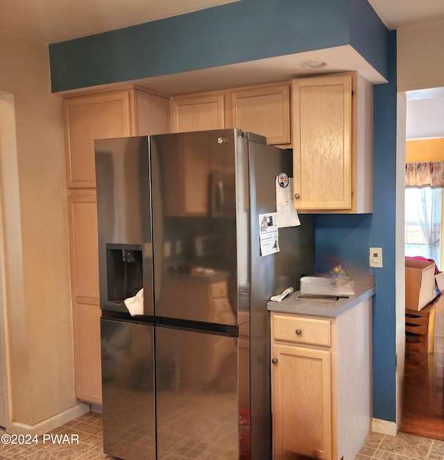 kitchen with stainless steel fridge with ice dispenser and light brown cabinets