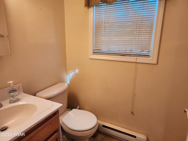 bathroom with vanity, toilet, and a baseboard heating unit