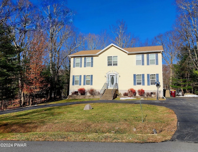 colonial home with a front yard