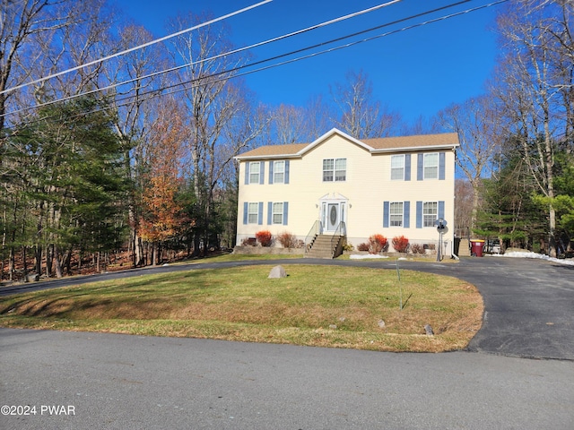 colonial inspired home with a front yard