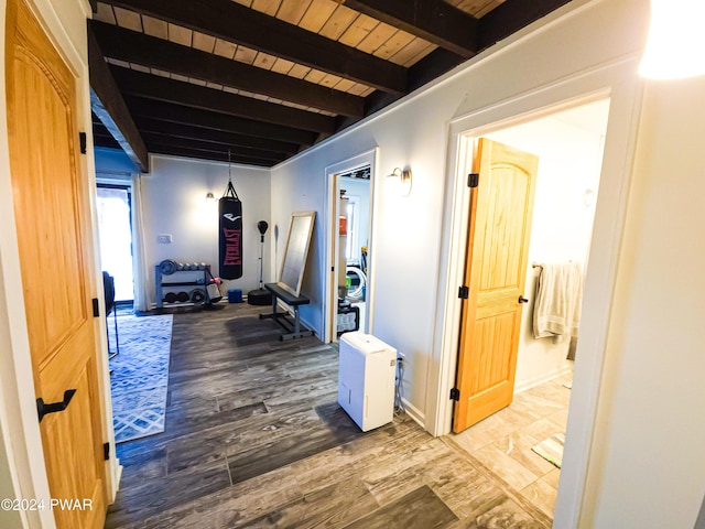 hall with hardwood / wood-style floors, beamed ceiling, and wooden ceiling