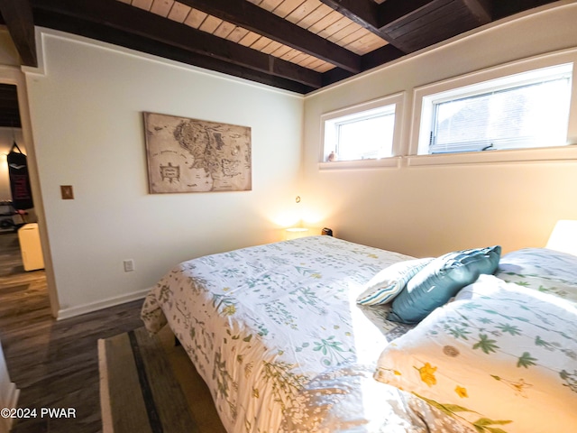 bedroom with beamed ceiling, dark hardwood / wood-style flooring, and wooden ceiling