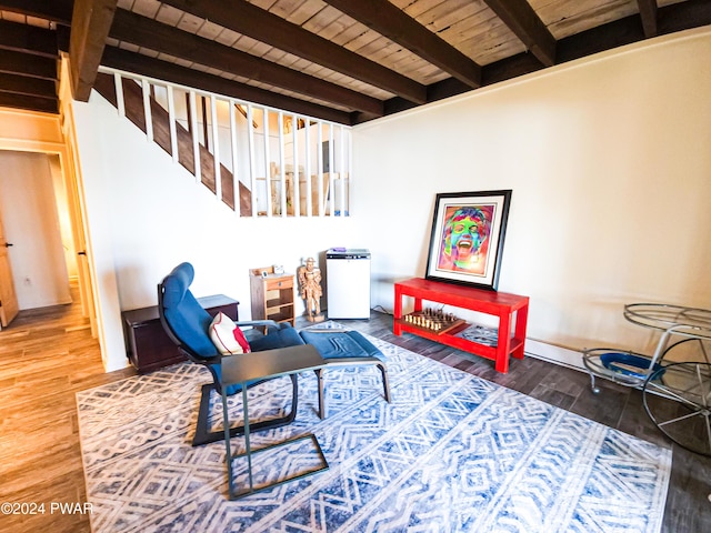 living area with beam ceiling, wooden ceiling, and hardwood / wood-style flooring