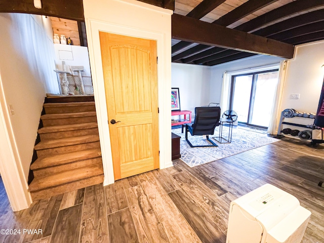 staircase featuring beamed ceiling, hardwood / wood-style flooring, and wooden ceiling