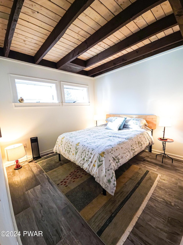 bedroom featuring beam ceiling, dark wood-type flooring, and wooden ceiling