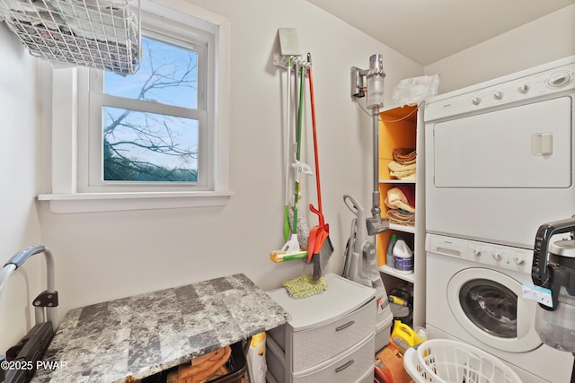 washroom featuring stacked washer / drying machine