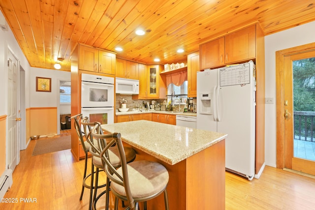 kitchen with a center island, decorative backsplash, white appliances, light stone countertops, and wooden ceiling