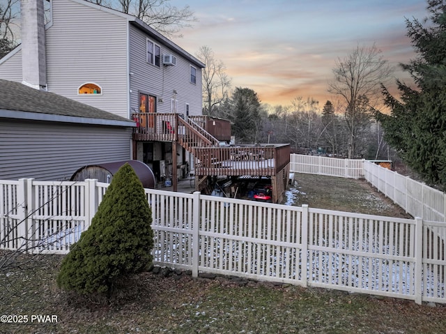 back house at dusk with a deck