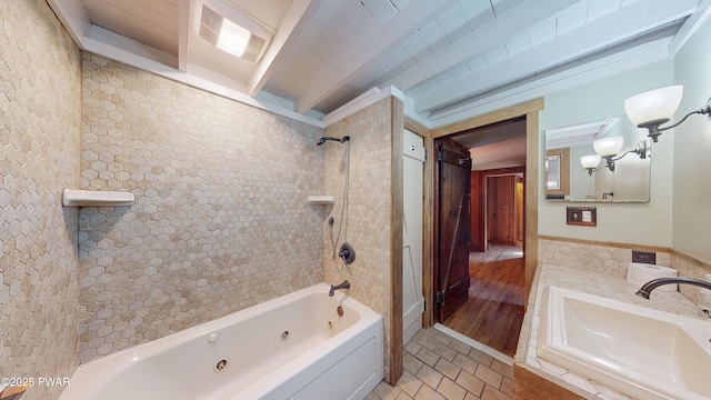 bathroom with tiled shower / bath, vanity, and beam ceiling