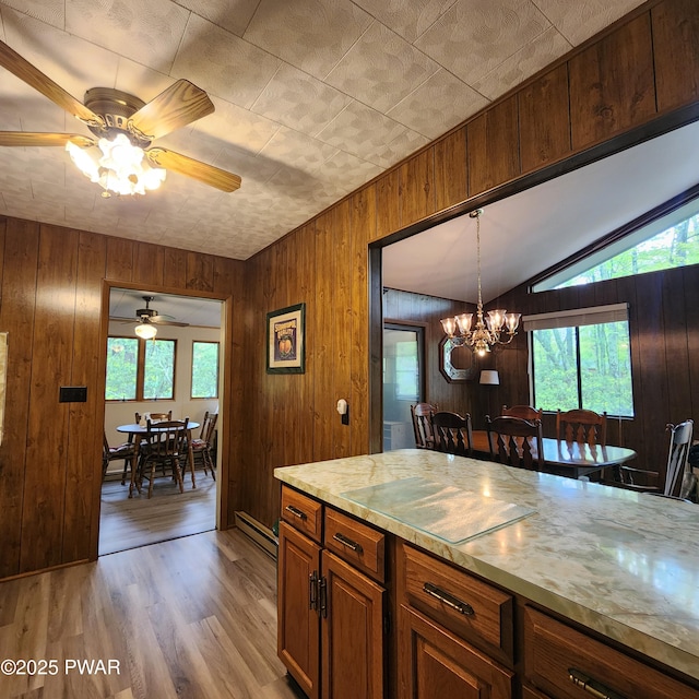 802 Placer Ct, Lords Valley, PA 18428 - kitchen featuring a chandelier, wooden walls, light wood finished floors, lofted ceiling, and a ceiling fan