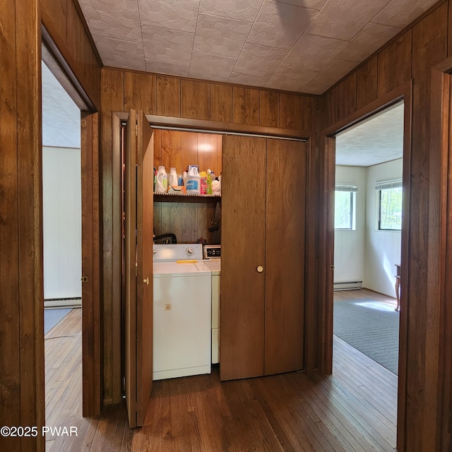 802 Placer Ct, Lords Valley, PA 18428 - laundry room with washer and clothes dryer, wood walls, hardwood / wood-style flooring, a baseboard heating unit, and baseboard heating
