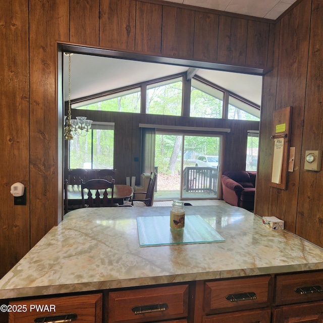 802 Placer Ct, Lords Valley, PA 18428 - kitchen with wood walls, light countertops, a chandelier, open floor plan, and a center island