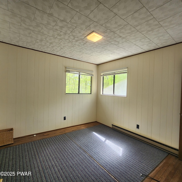 802 Placer Ct, Lords Valley, PA 18428 - empty room featuring a baseboard heating unit and wooden walls