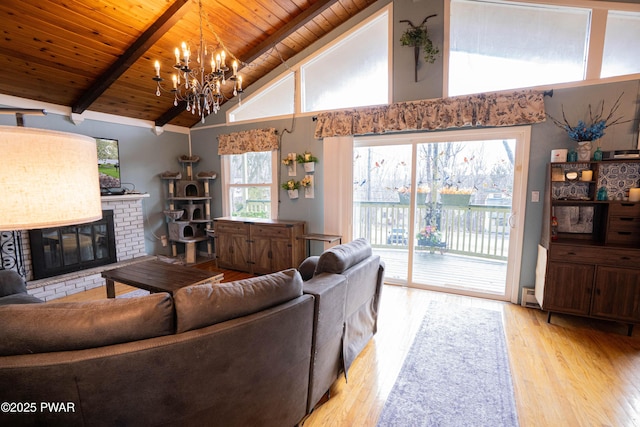 living room with light wood finished floors, beamed ceiling, a brick fireplace, and wood ceiling