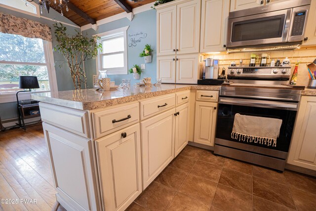 kitchen featuring light stone counters, backsplash, lofted ceiling with beams, appliances with stainless steel finishes, and wooden ceiling