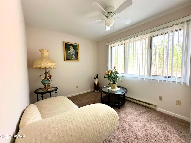 sitting room with a baseboard radiator, a ceiling fan, carpet, and baseboards