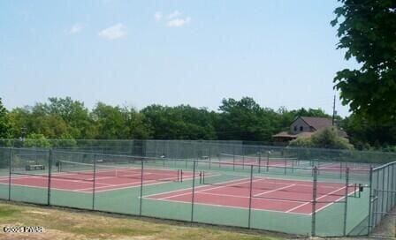 view of sport court featuring fence