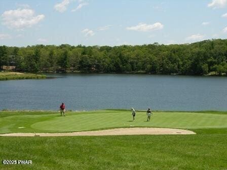 surrounding community featuring a water view, golf course view, and a yard