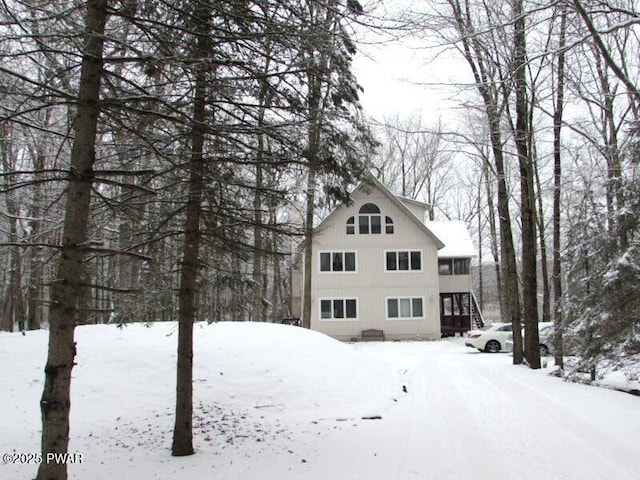 view of snowy exterior featuring stairs