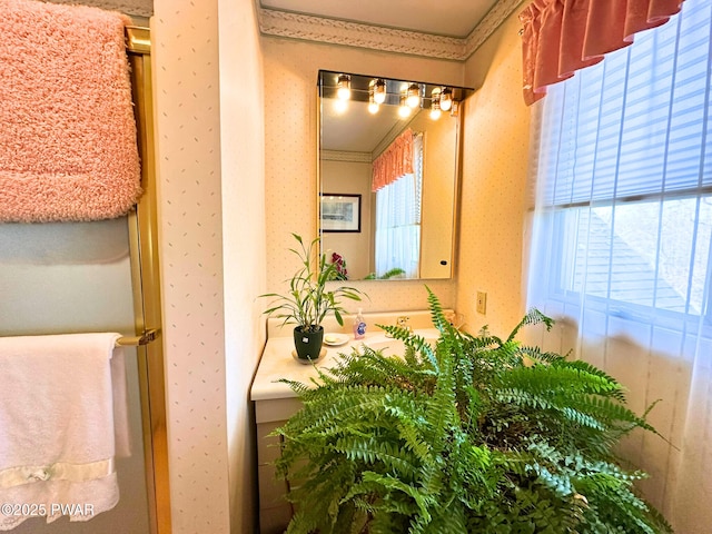 bathroom with wallpapered walls