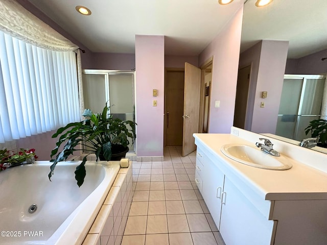 bathroom with a stall shower, recessed lighting, a garden tub, vanity, and tile patterned flooring