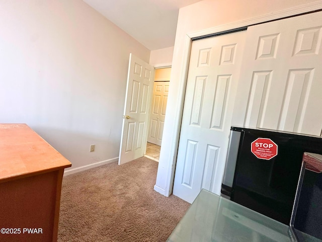 unfurnished office with carpet flooring and baseboards