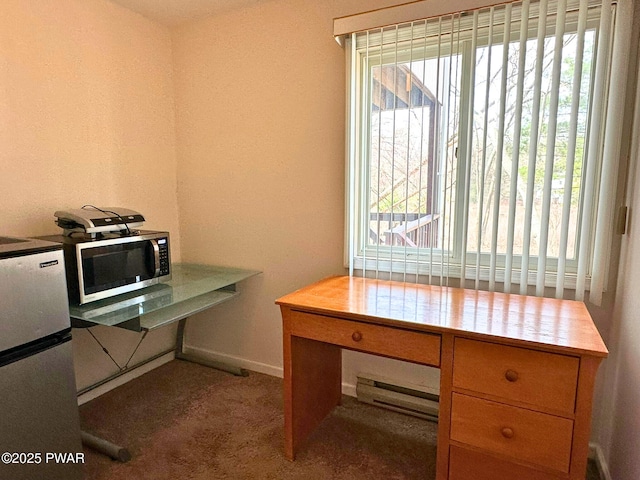 carpeted office space with baseboards and a baseboard heating unit