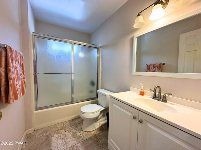 full bath featuring baseboards, toilet, combined bath / shower with glass door, and vanity