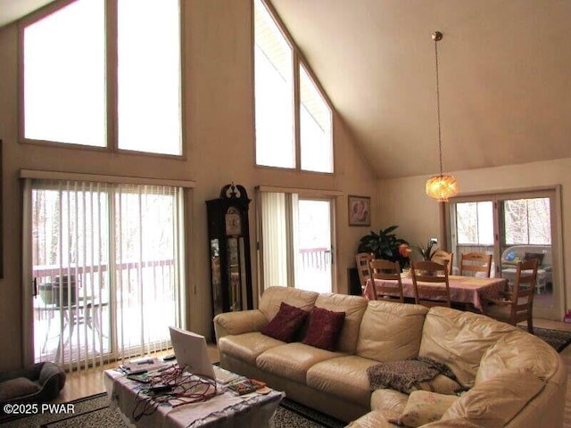 living area with high vaulted ceiling